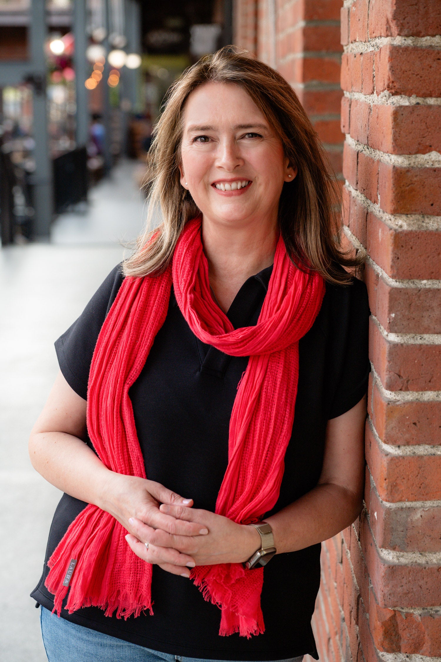 The author leaning against a brick wall