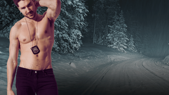 Man with a tattoo on his chest standing in a snowy forest